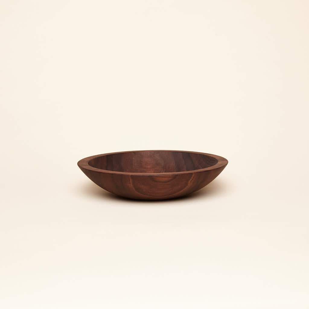 A shallow small walnut wood nesting bowl