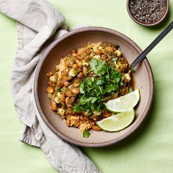 Spam Infused Fried Rice in an Everyday Bowl with a fried egg on top. Photographed on a bright yellow background. Giving us all the "fast food" vibes.