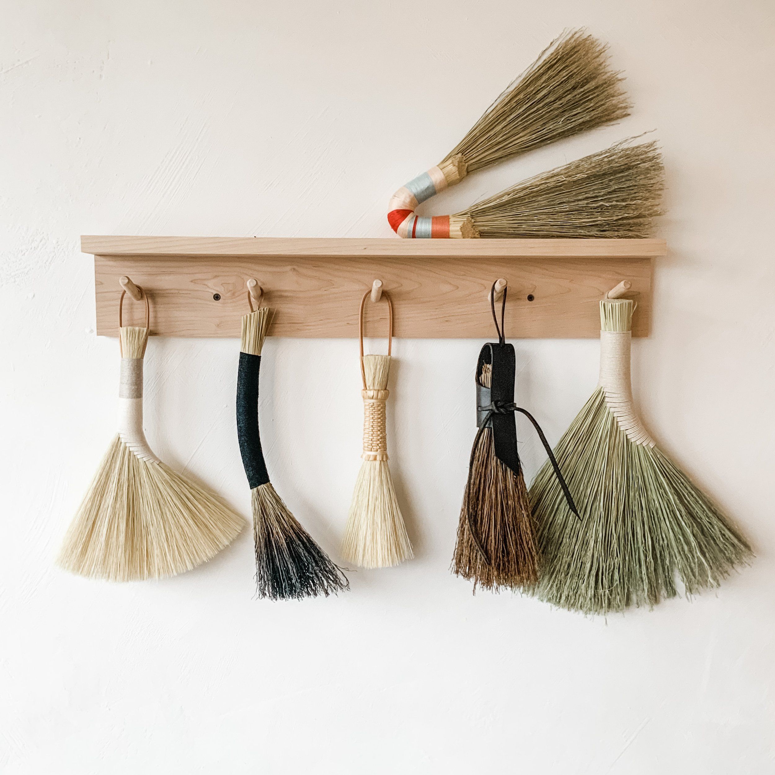Samples of brooms hanging on hooks