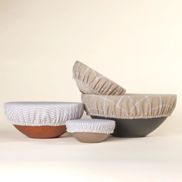 Mixing bowl, popcorn bowl, soup bowl, and ice cream bowl with linen bowl covers on them in neutral and cool white patterns.