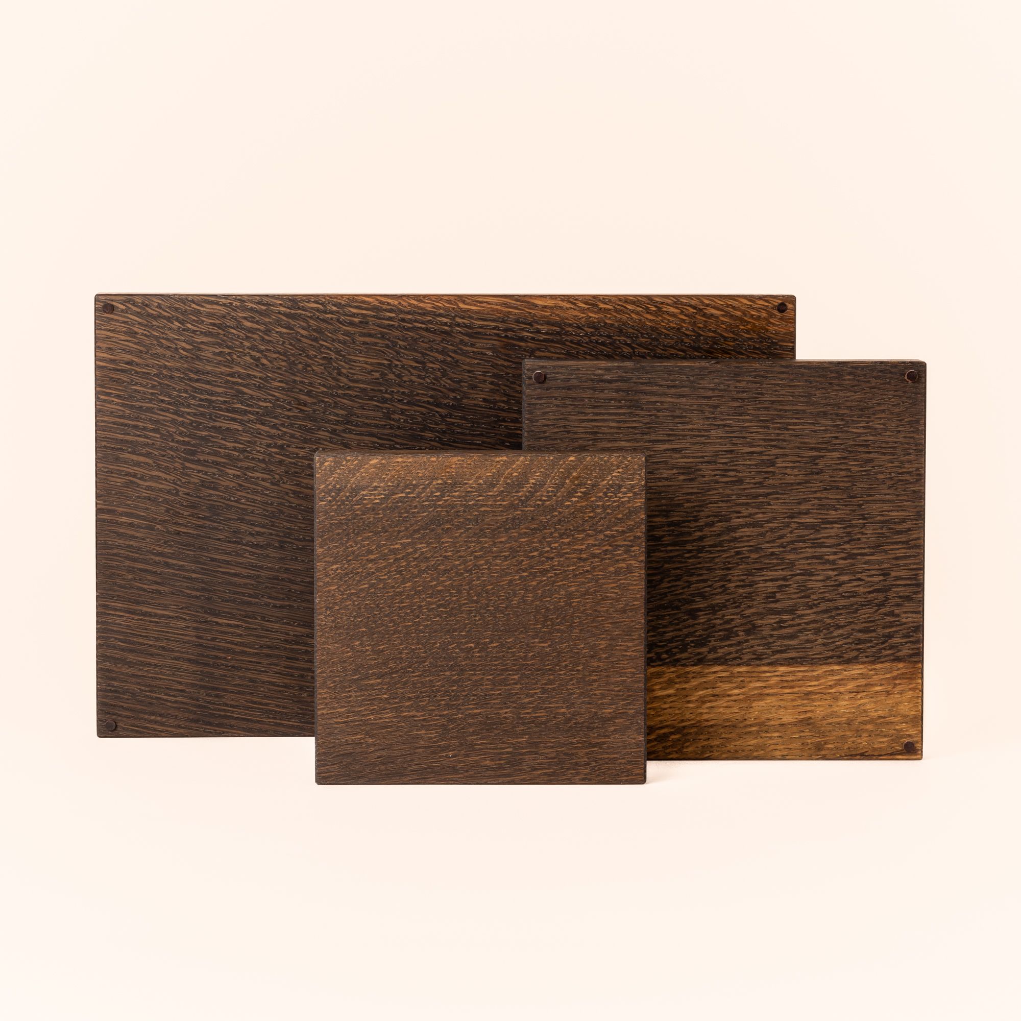 Three oak cutting boards of varying sizes in an ebonized stain