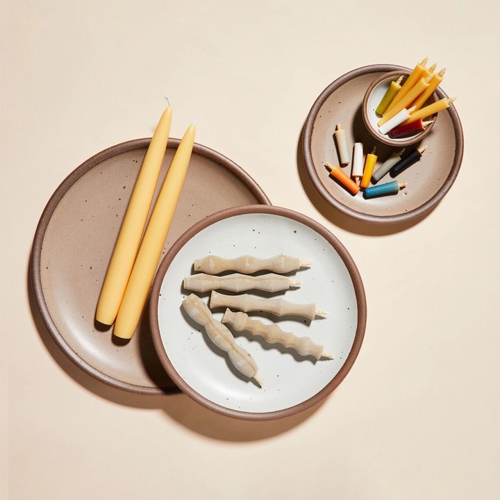 East Fork pottery with candles in different shapes and sizes