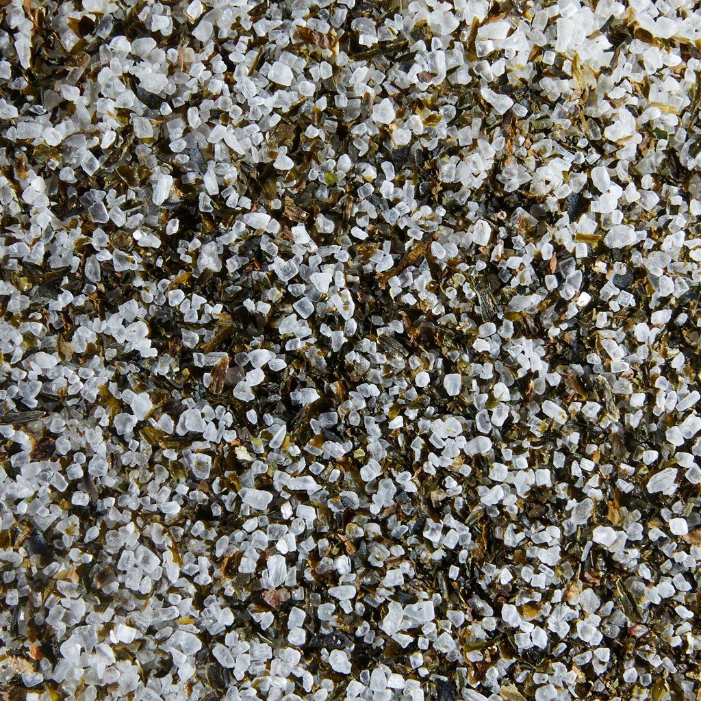 Seaweed salt with white grains of salt and tiny green pieces of seaweed 