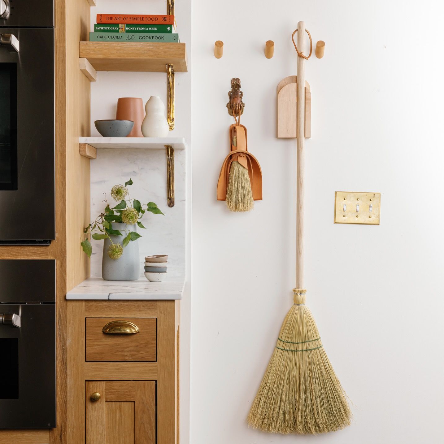 Black Donabe styled with fresh scallions, sesame, and serving pieces for a modern, elevated kitchen vignette.