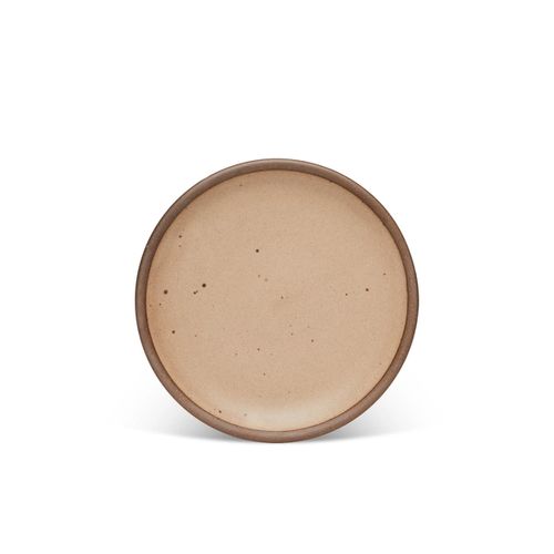 A medium sized ceramic plate in a warm pale brown color featuring iron speckles and an unglazed rim.