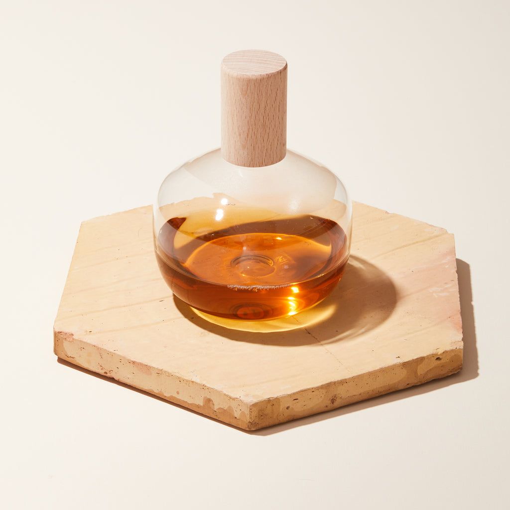 Clear bottles used for oil and vinegar with a wooden lid and cork spout