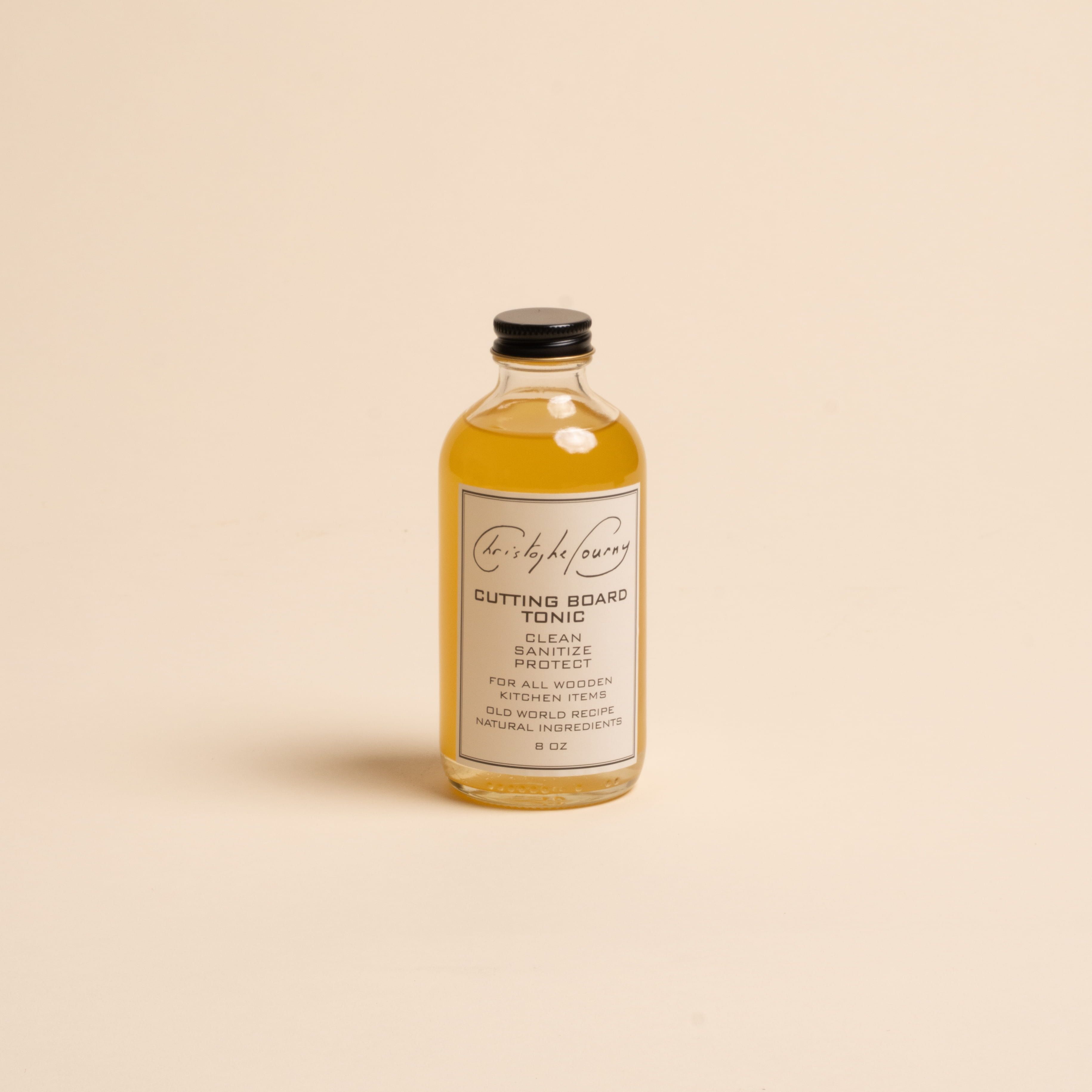Glass bottle with a black screw top and a white label that reads "Cutting Board Tonic"