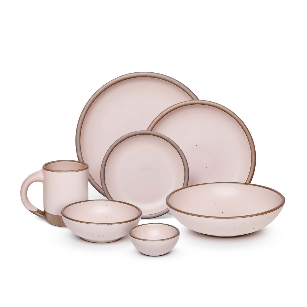 The Mug, bitty bowl, breakfast bowl, everyday bowl, cake plate, side plate and dinner plate paired together in a soft light pink color featuring iron speckles