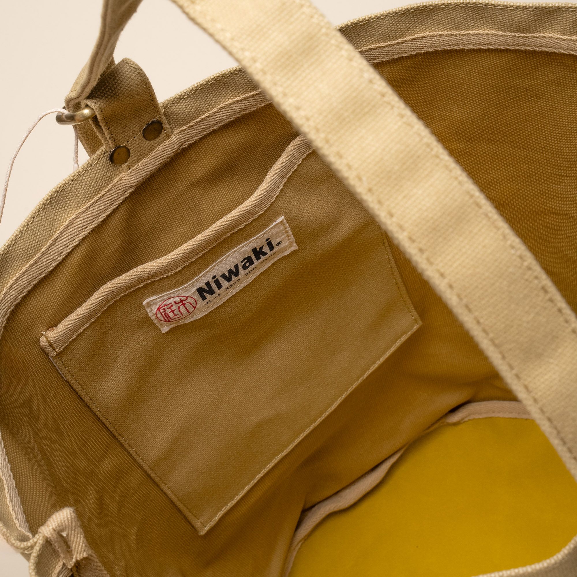 Inside look at the interior pocket of a large canvas bucket tote