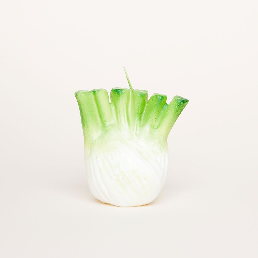 A green and white candle with the shape, size and texture of a bulb of fennel