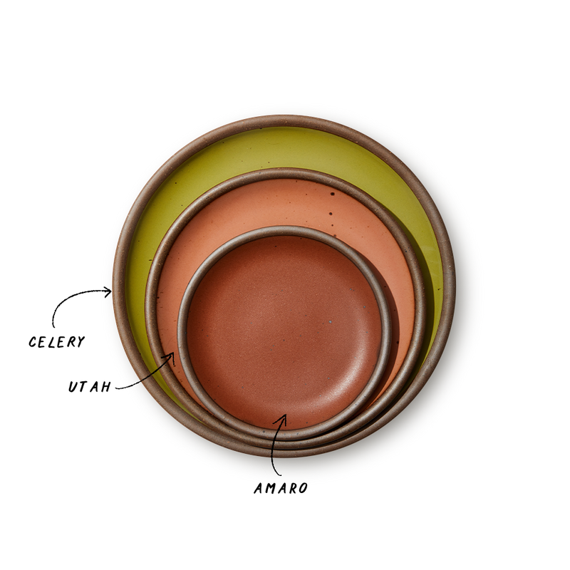 A stack of 3 plates in Dinner, Side, and Cake sizes in a celery green, peach, and terracotta colors.