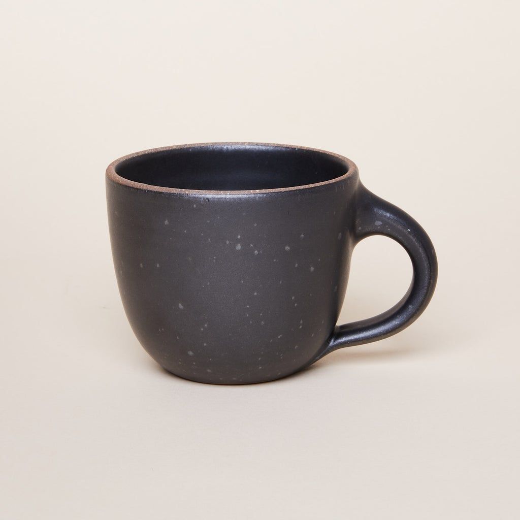 Sunday Morning Mug in Black Mountain, a graphite black color featuring iron speckles and an unglazed rim