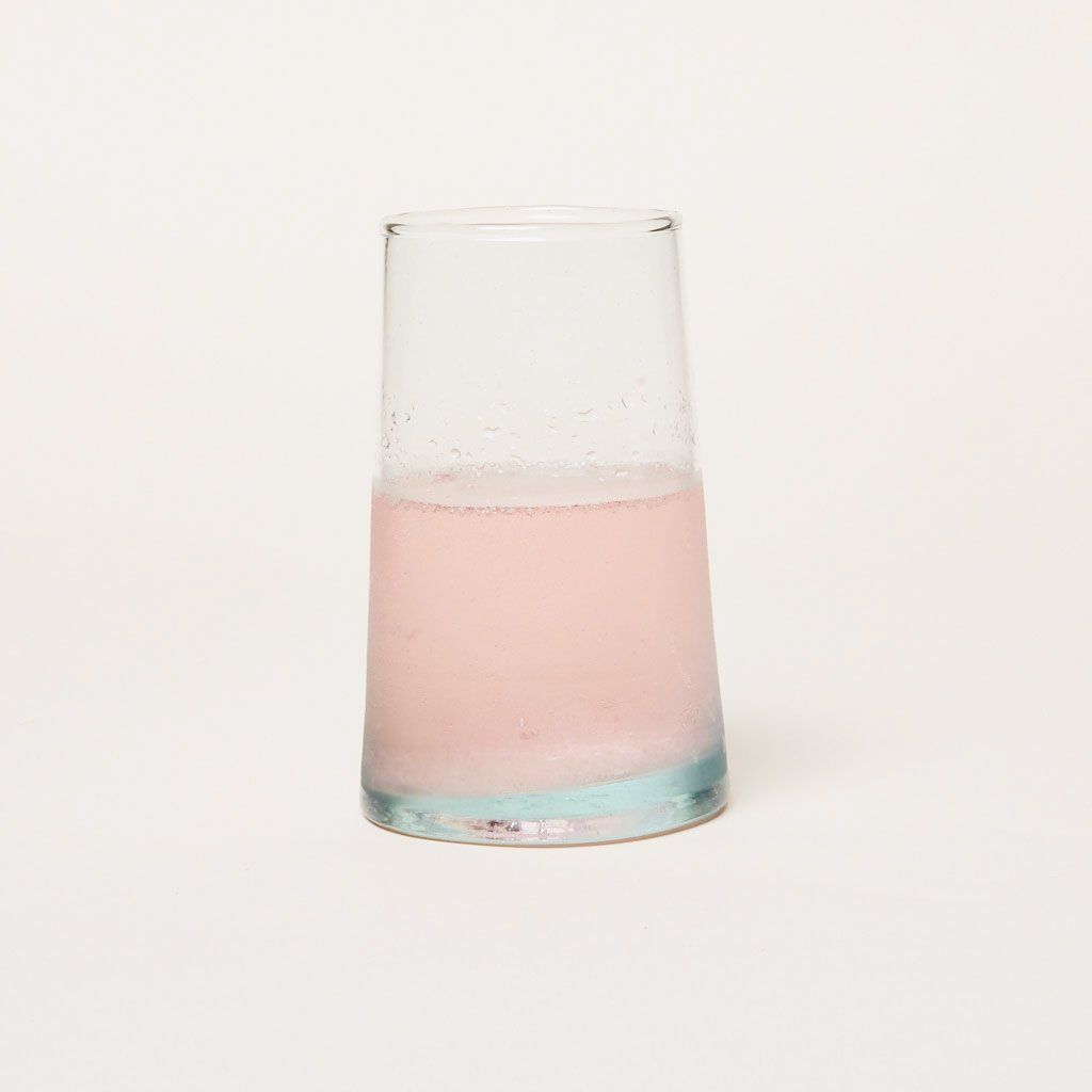 Recycled Moroccan glassware tall glass half-filled with pink liquid