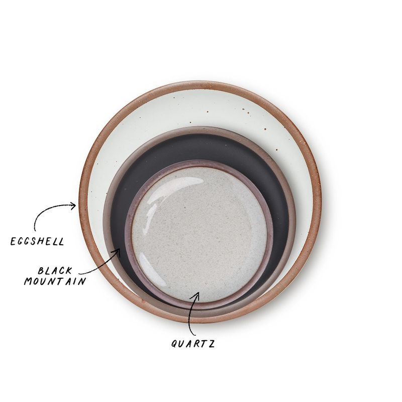 A stack of 3 plates in Dinner, Side, and Cake sizes in a cool white, graphite black, and reflective icy white colors.