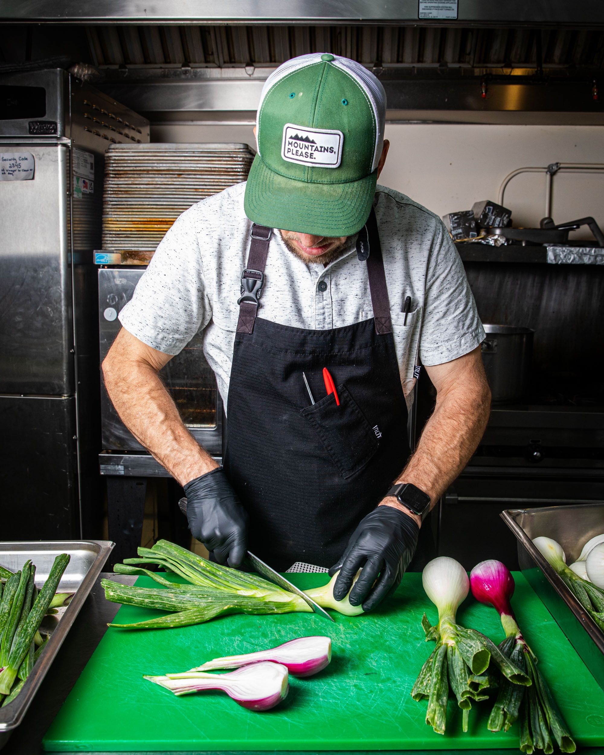 In a kitchen, a person prepares vegetables for a meal