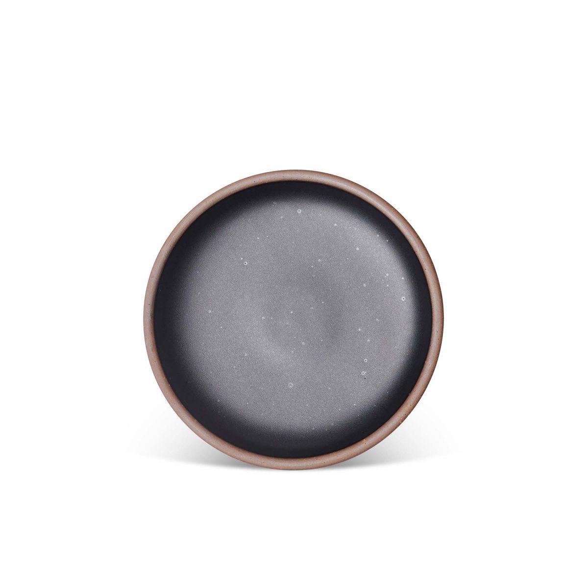 A medium sized ceramic plate in a graphite black color featuring iron speckles and an unglazed rim.