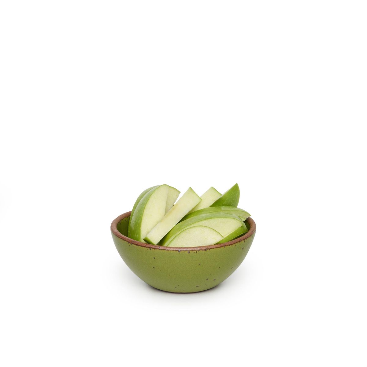 Ice Cream Bowl in Fiddlehead, a mossy, olive green. The bowl is perfect for two scoops of ice cream – but don't stop there. Here, it's pictured with granny smith apple slides. The perfect bowl for a snack.