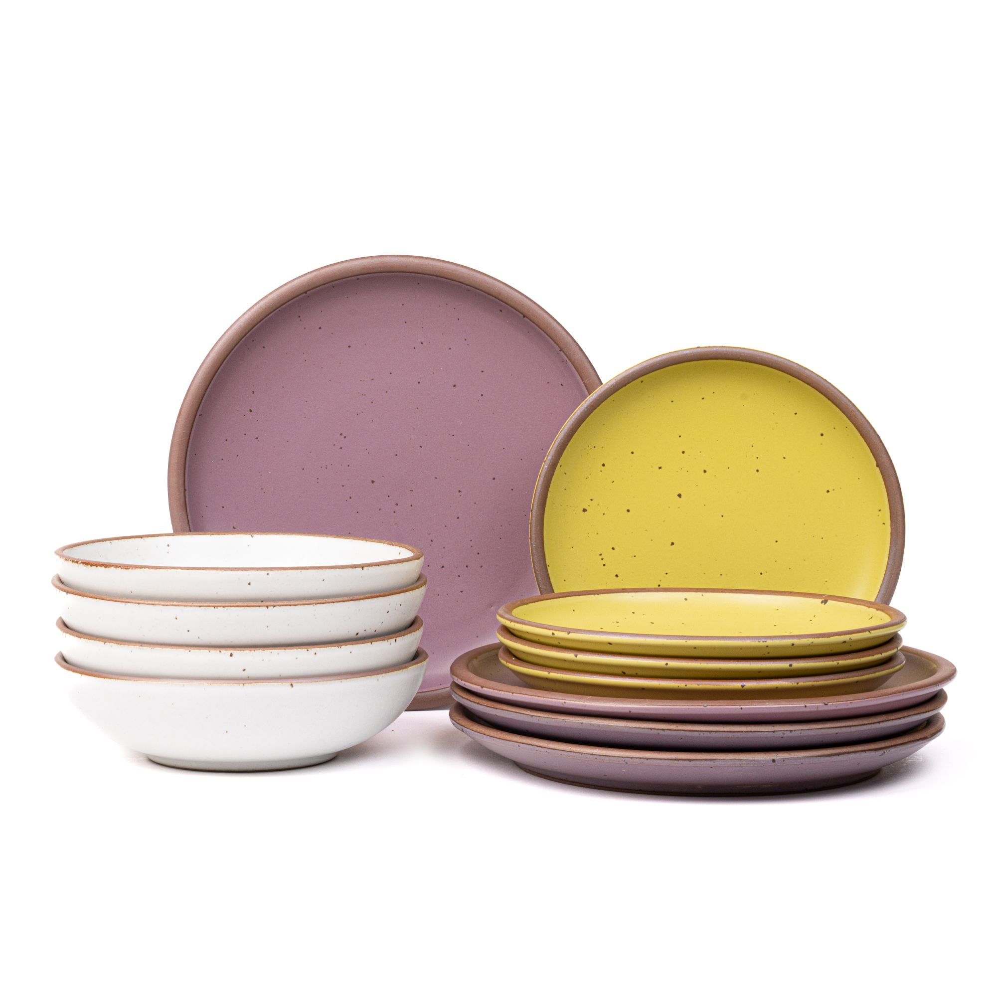 4 ceramic dinner plates in soft, mauve purple, 4 side plates in zesty yellow, and 4 shallow dinner bowls in white with iron speckles and unglazed rims.