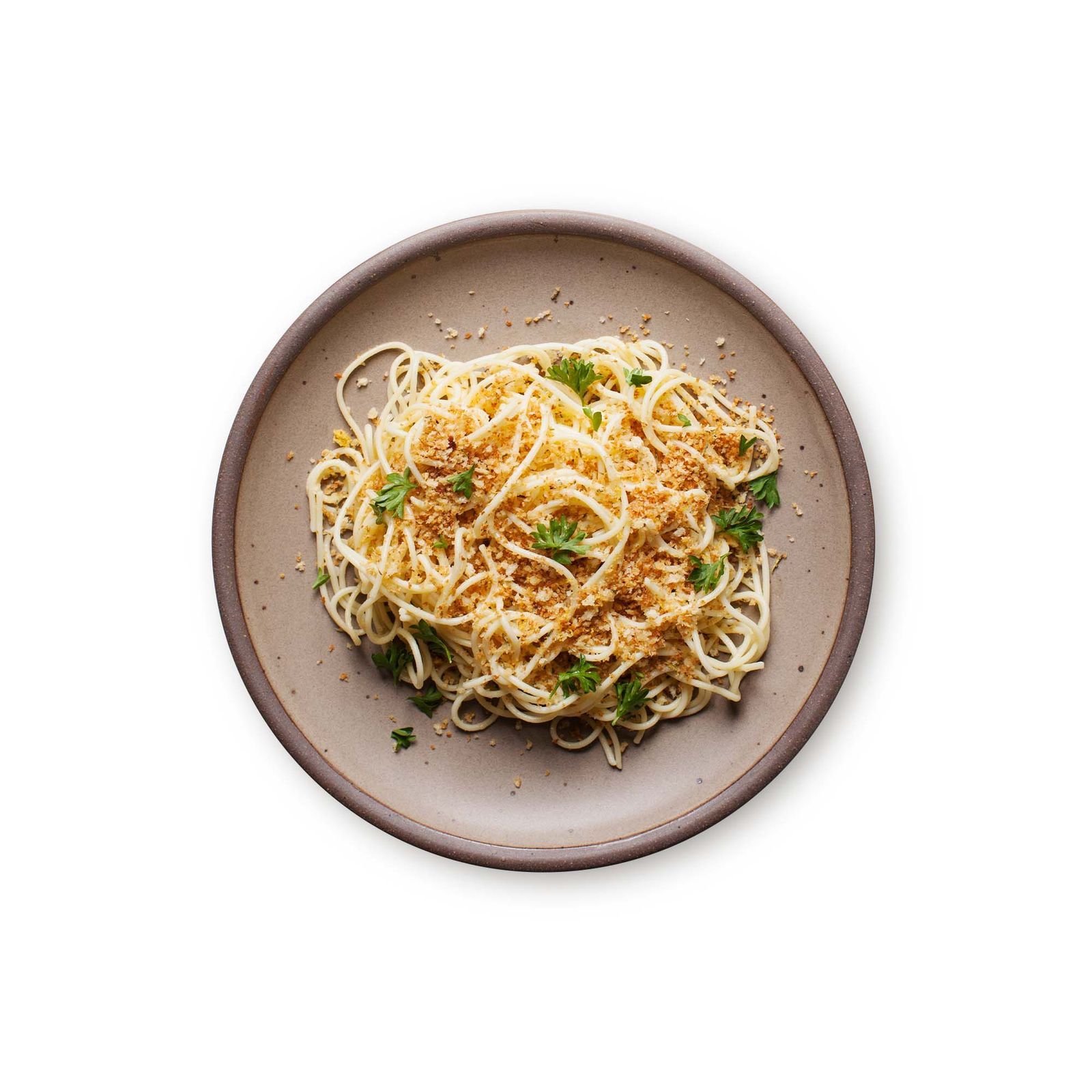 A dinner plate with a heaping serving of spaghetti with parsley and breadcrumbs sprinkled on top