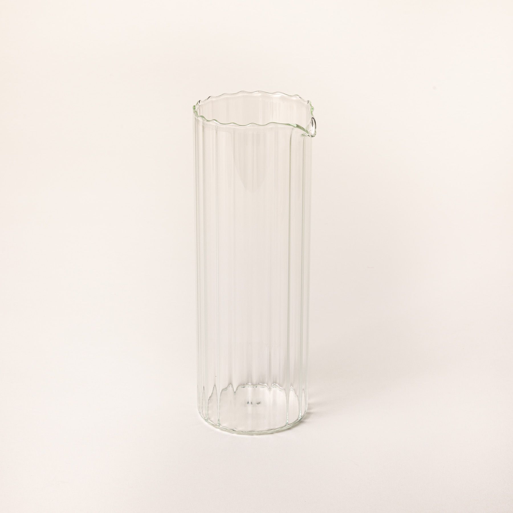 Tall cylindrical fluted pitcher with a spout on top