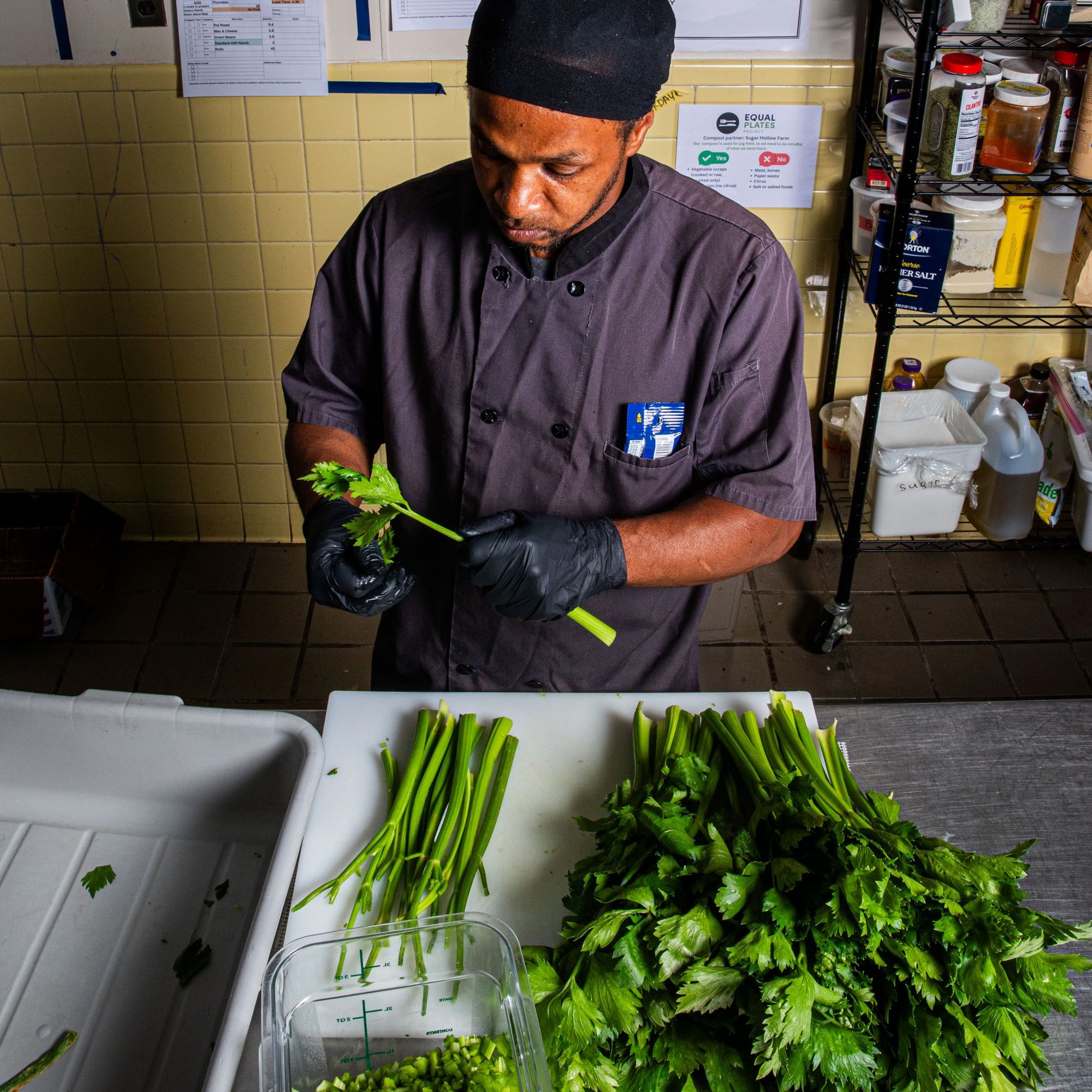 In a kitchen, a person prepares vegetables for a meal