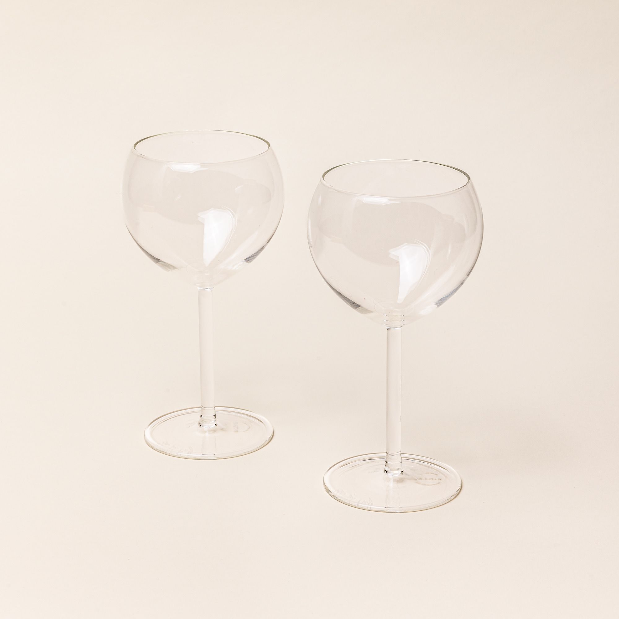 Two simple round clear wine glasses