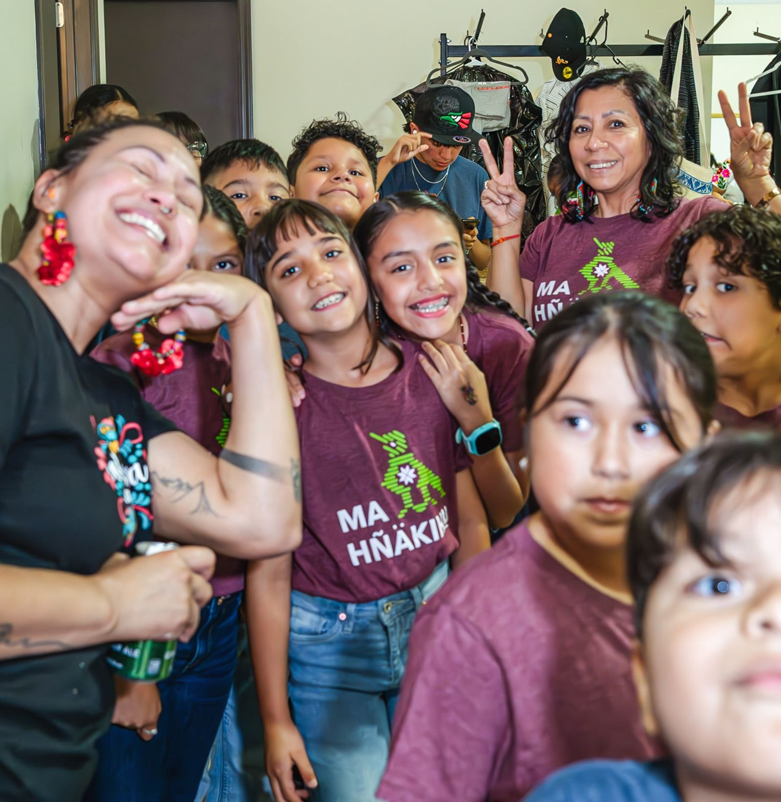 A group of children smiling at the camera in Ma Hnakihu t-shirts