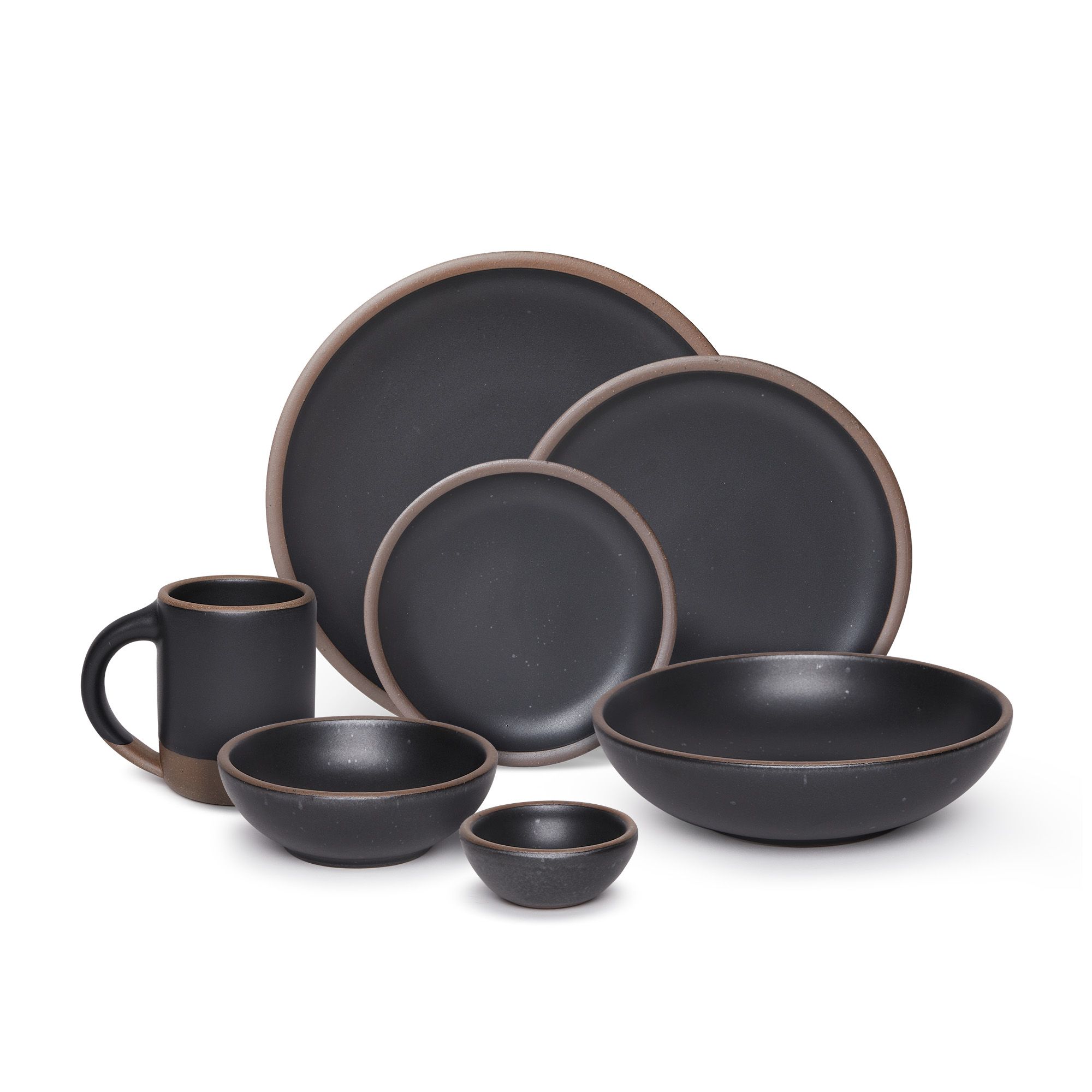 The Mug, bitty bowl, breakfast bowl, everyday bowl, cake plate, side plate and dinner plate paired together in a graphite black color featuring iron speckles