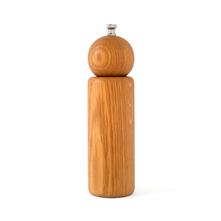 Simple pepper mill made of oak wood with a tall cylinder body with a sphere and small metal piece on top