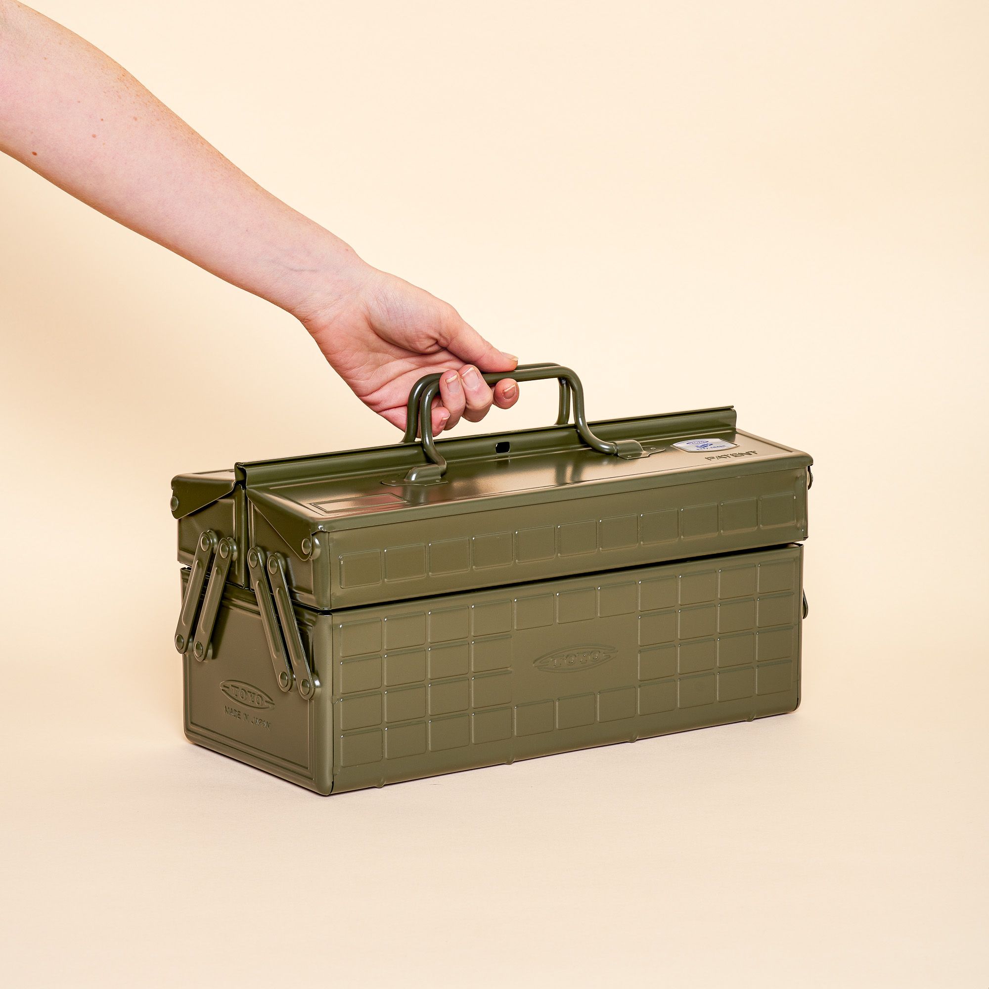 A army green organizer box that folds out to show off different compartments