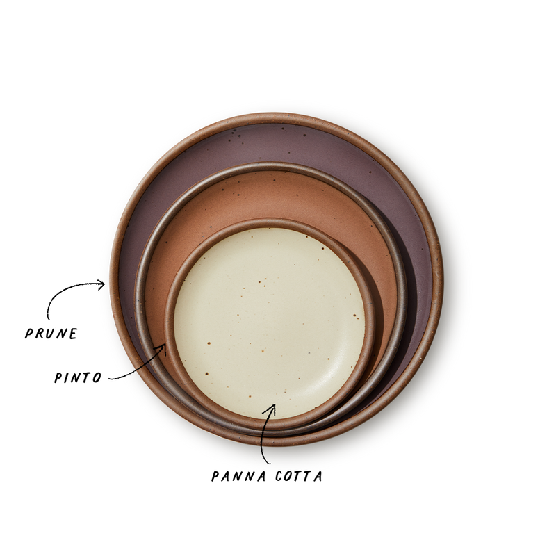 A stack of 3 plates in Dinner, Side, and Cake sizes in a muted purple, soft terracotta, and warm off-white colors.