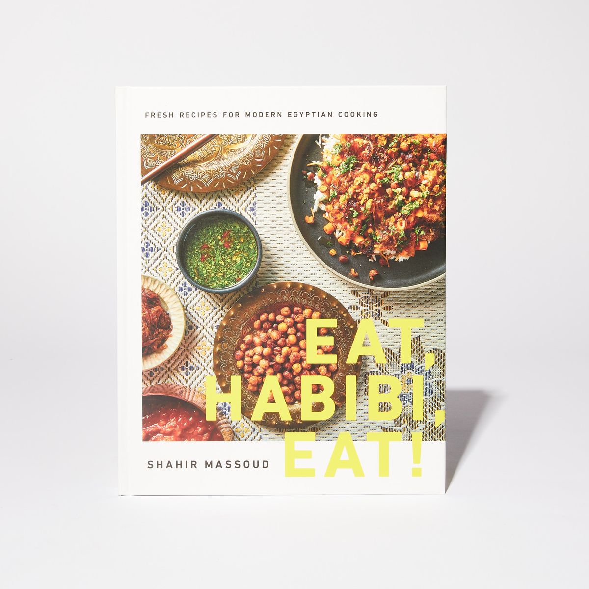 Book cover with several photos of colorful Egyptian dishes with the title "Eat Habibi, Eat!", the name "Shahir Massoud", and the text "Fresh Recipes for Modern Egyptian Cooking"