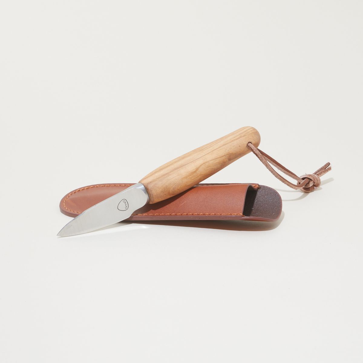 An oyster knife with a wooden handle resting on its leather sheath