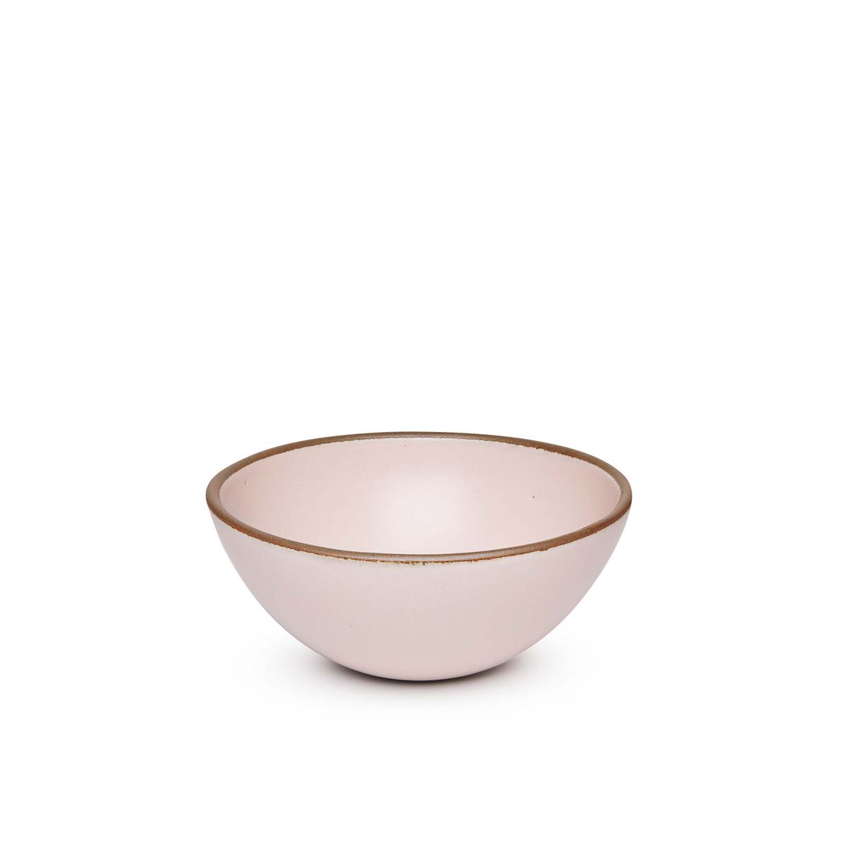 A medium rounded ceramic bowl in a soft light pink color featuring iron speckles and an unglazed rim