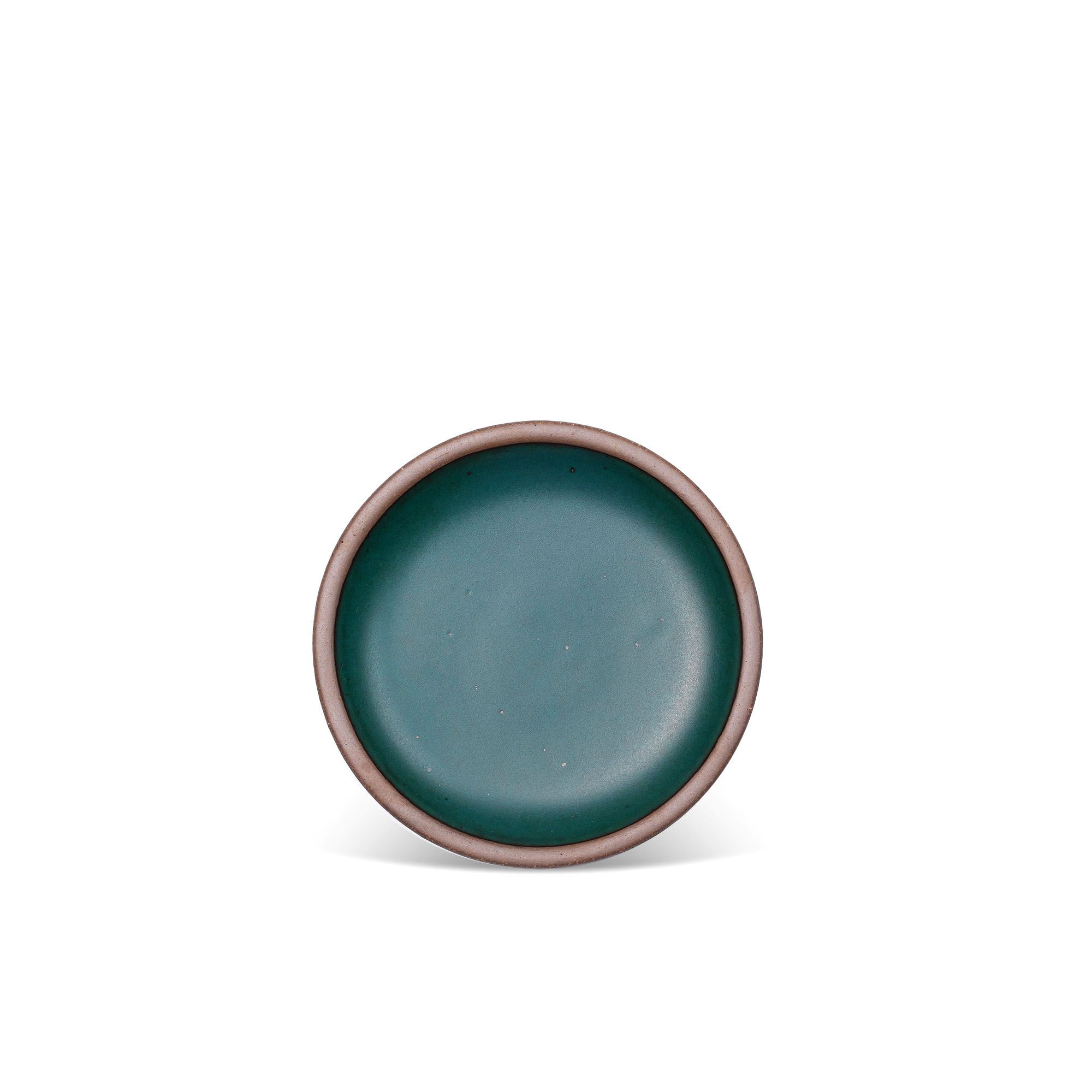 A dessert sized ceramic plate in a deep dark teal color featuring iron speckles and an unglazed rim