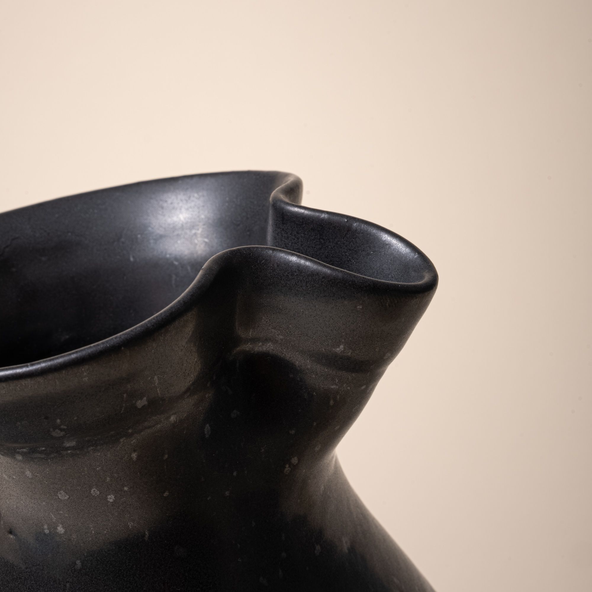A closeup detail photo of the hand formed spout of a ceramic pitcher
