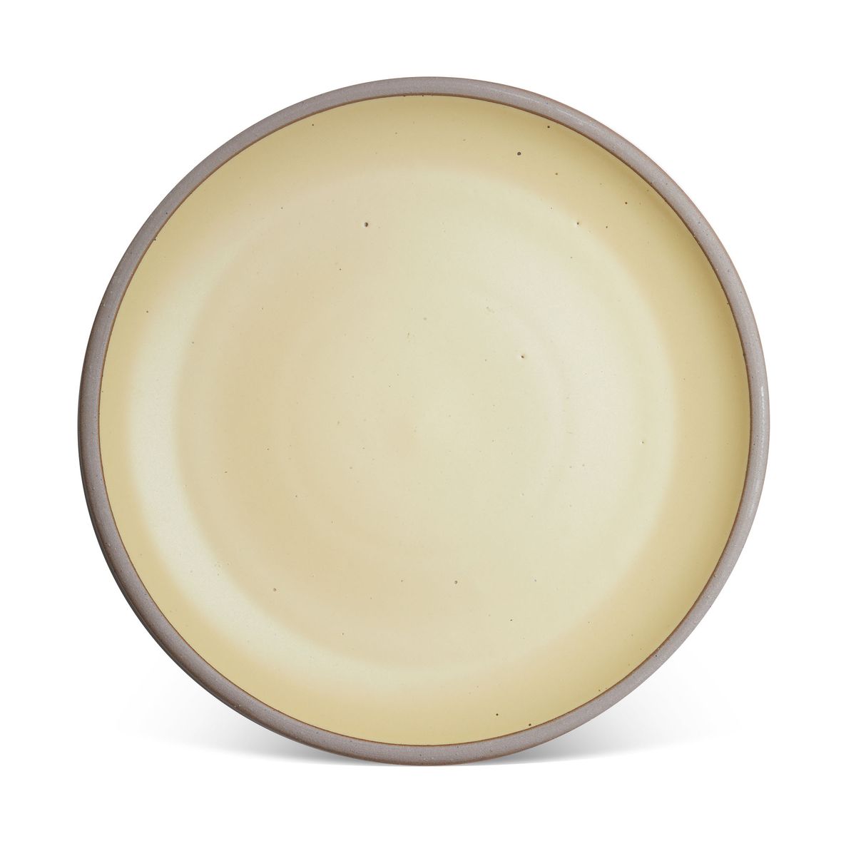 A large ceramic platter in a light butter yellow color featuring iron speckles and an unglazed rim