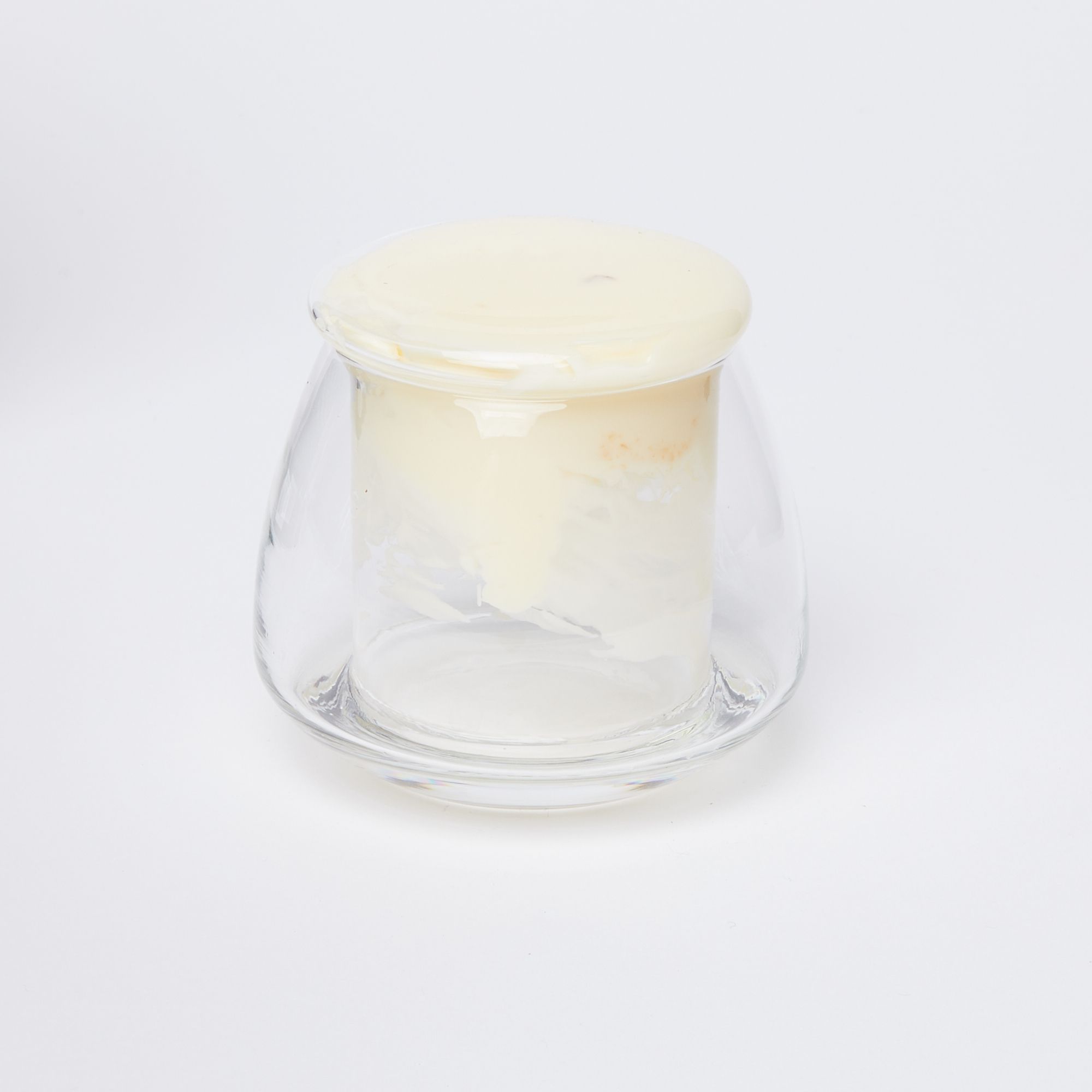 Clear glass butter keeper filled with light yellow butter