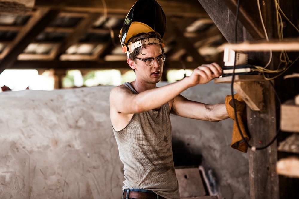 John outside working with the original wood-fired kiln