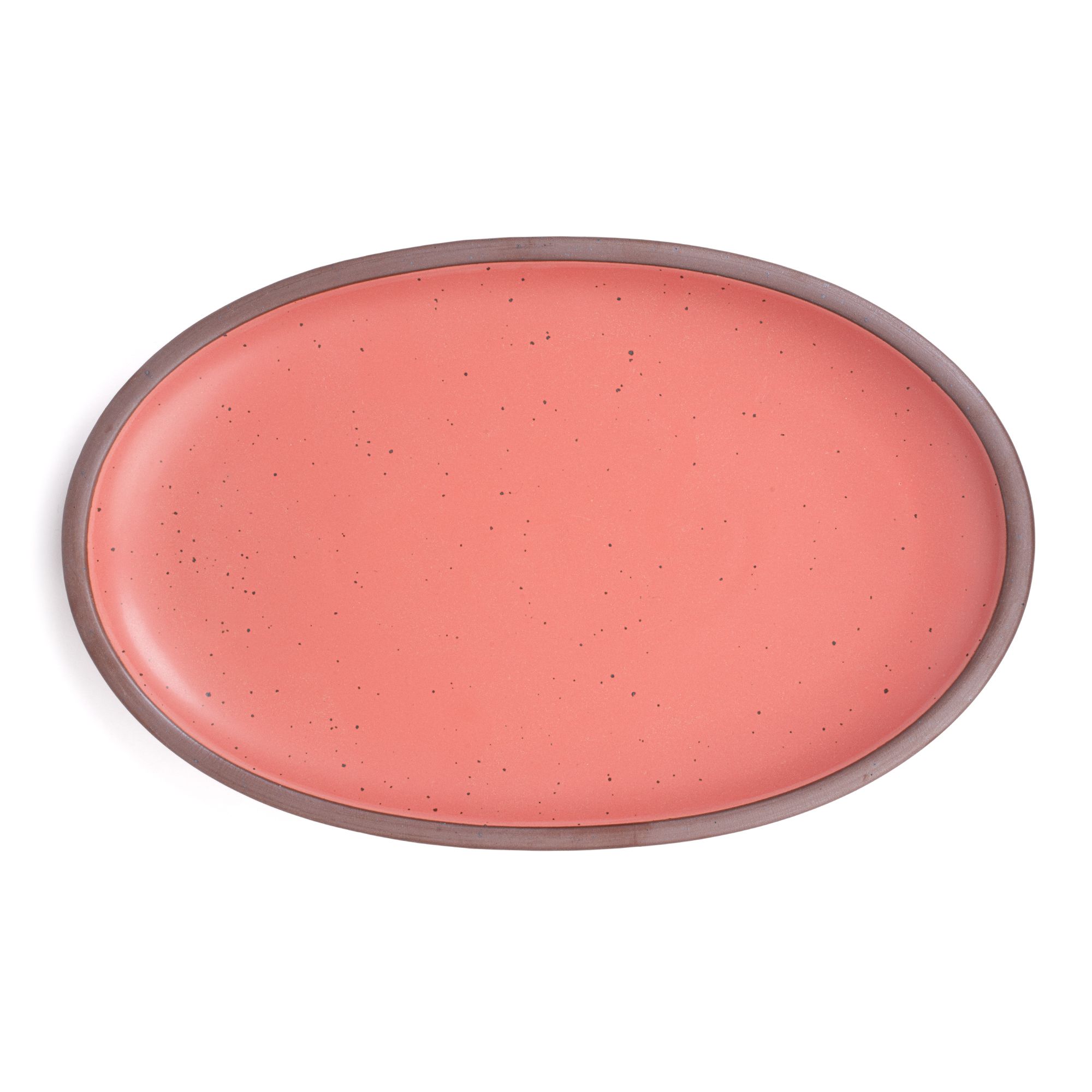 A large oval ceramic platter in a watermelon pink color featuring iron speckles and an unglazed rim