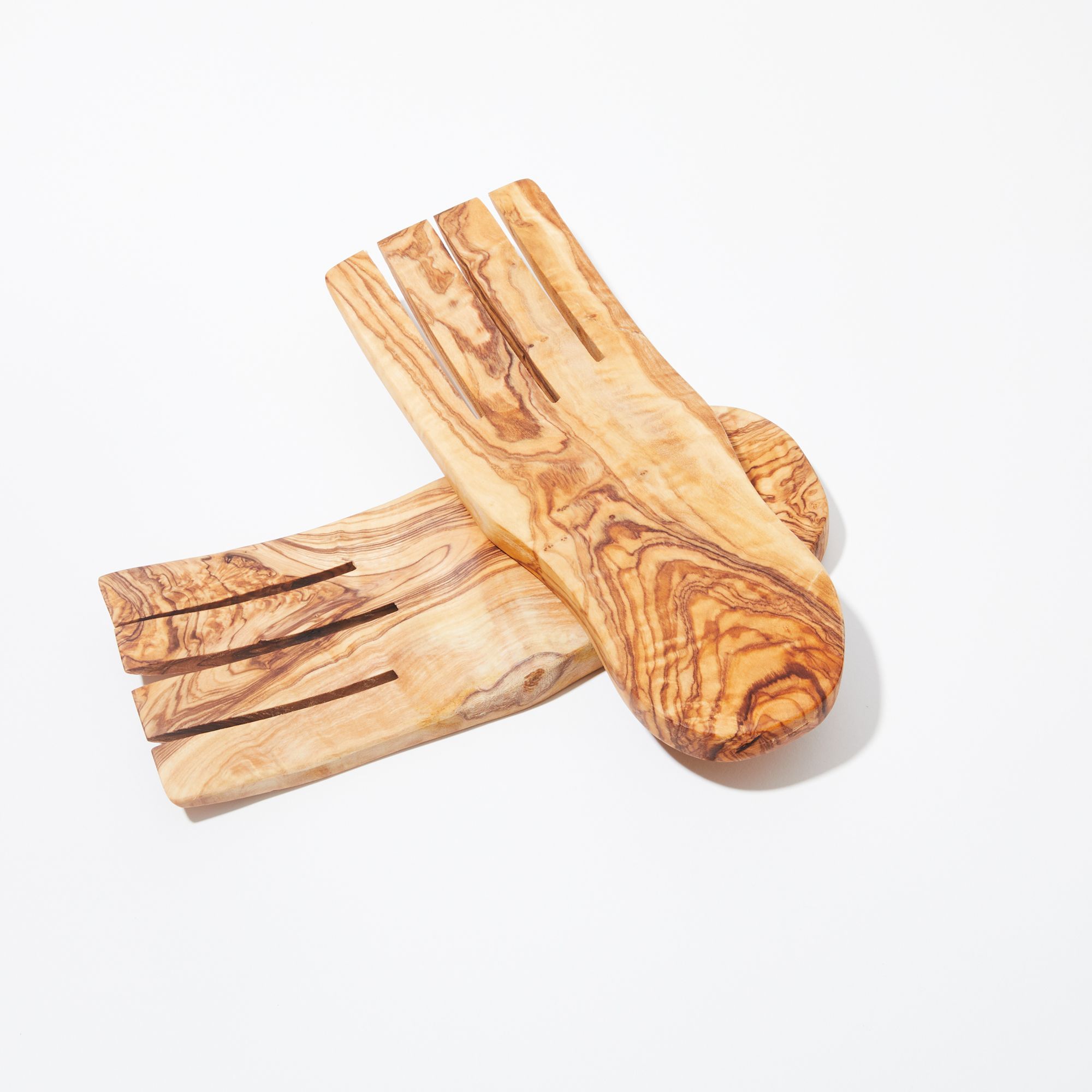 A pair of olivewood serving utensils overlapping