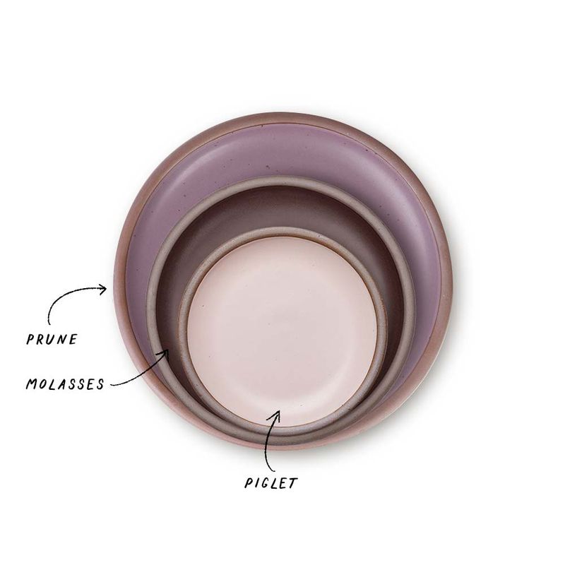 A stack of 3 plates in Dinner, Side, and Cake sizes in a soft mauve purple, dark brown, and baby pink colors.