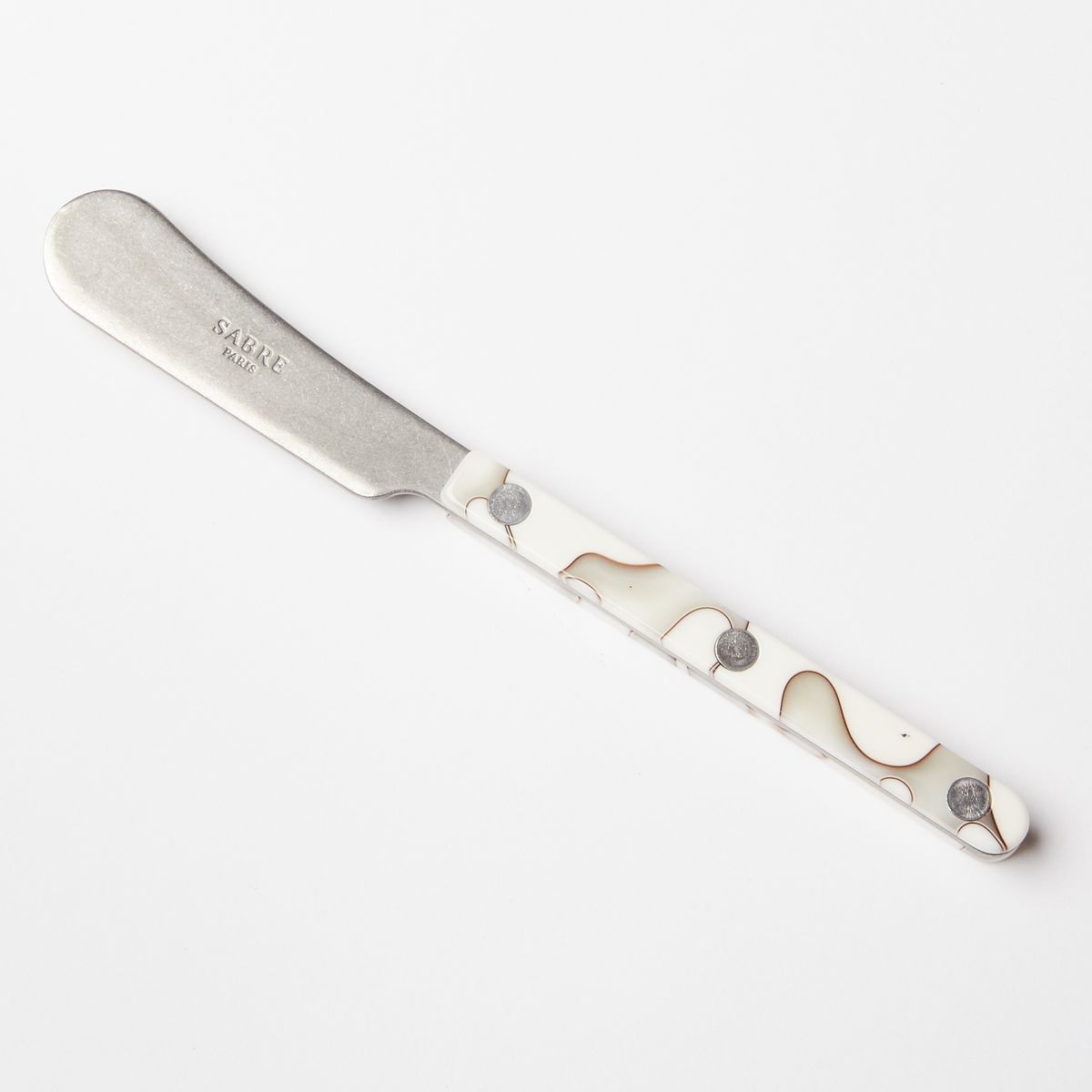 A butter knife with a stainless steel blade and an acrylic white and grey handle