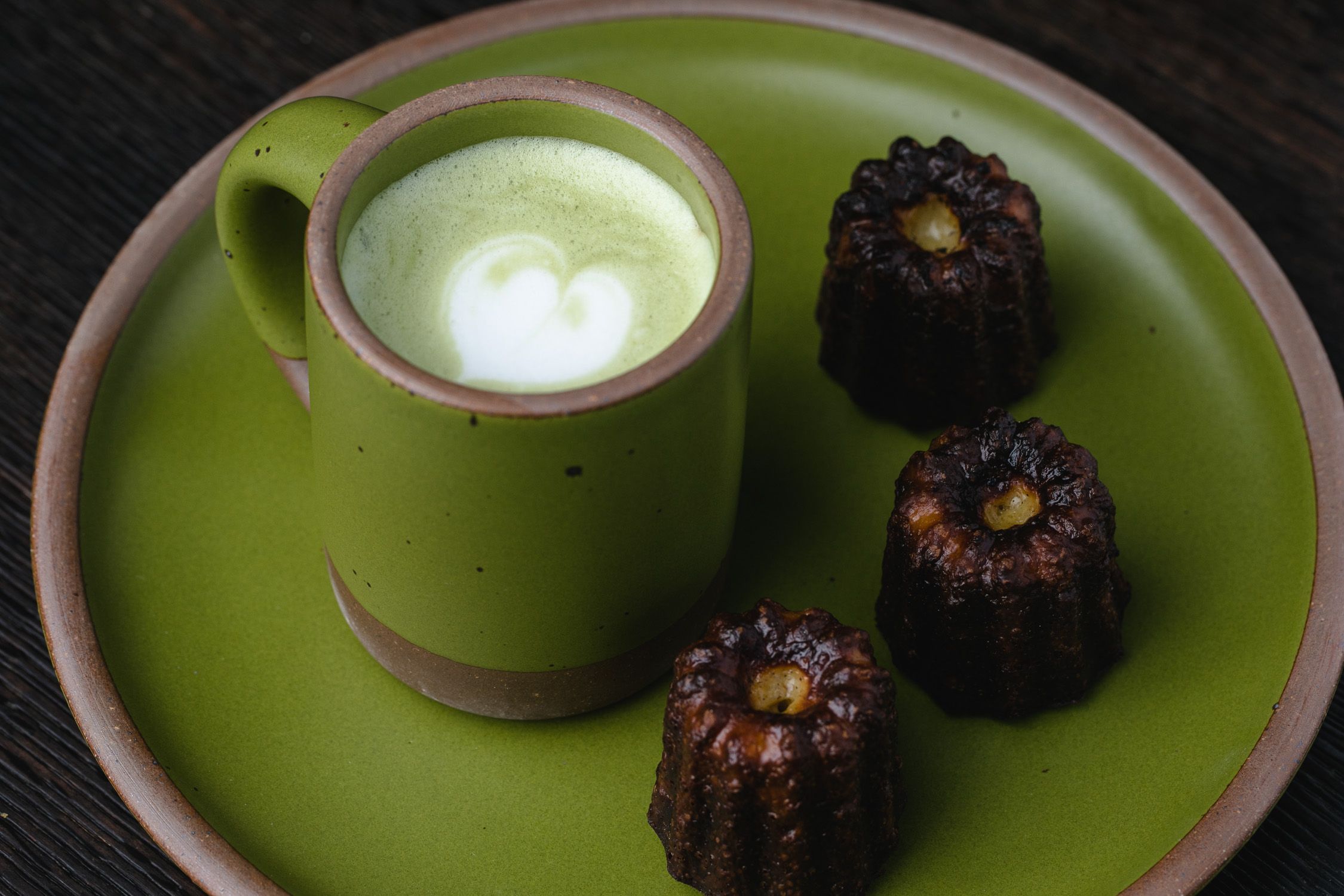 Matcha latte with caneles in Fiddlehead mug and side plate