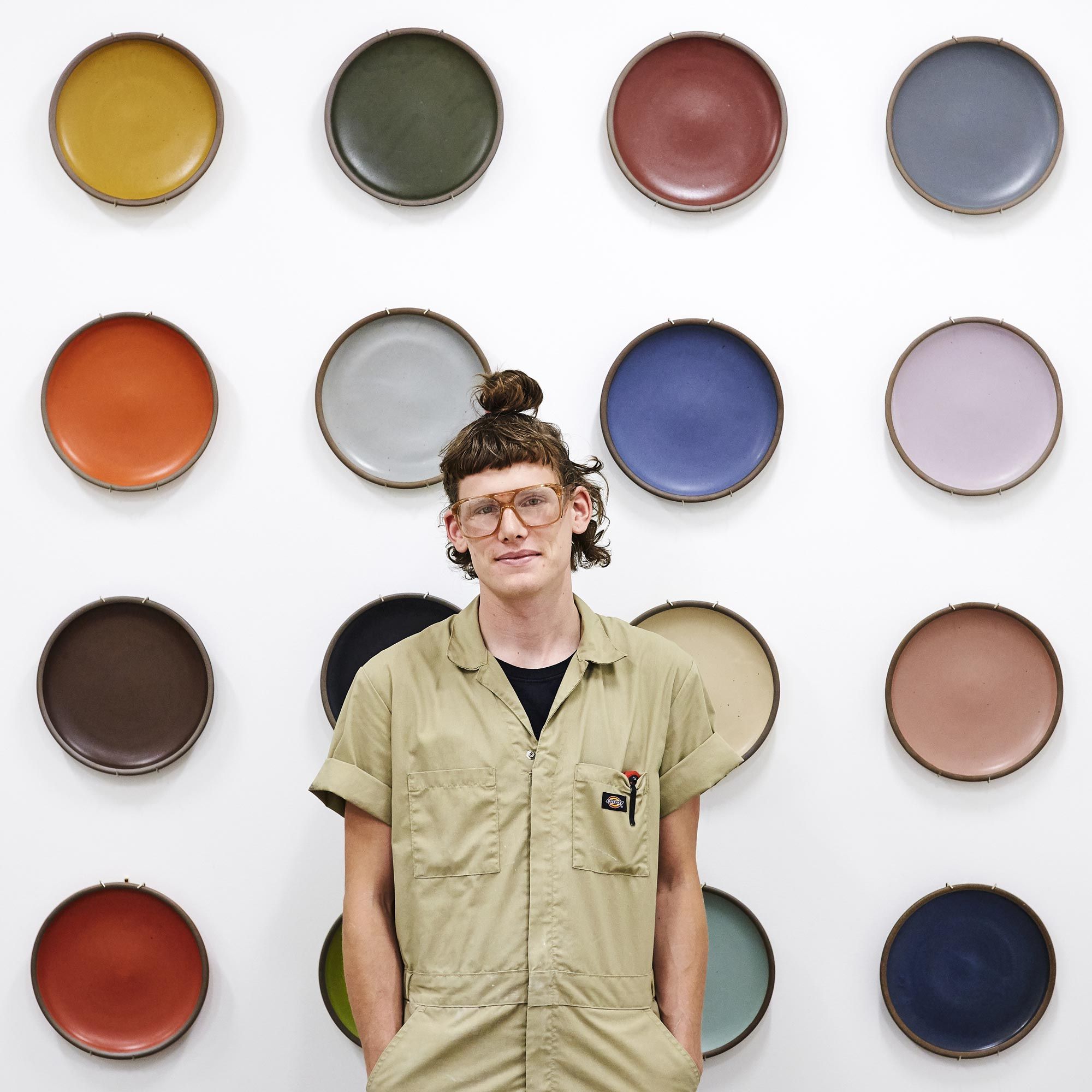 Kyle Crowder in front of glaze plate wall