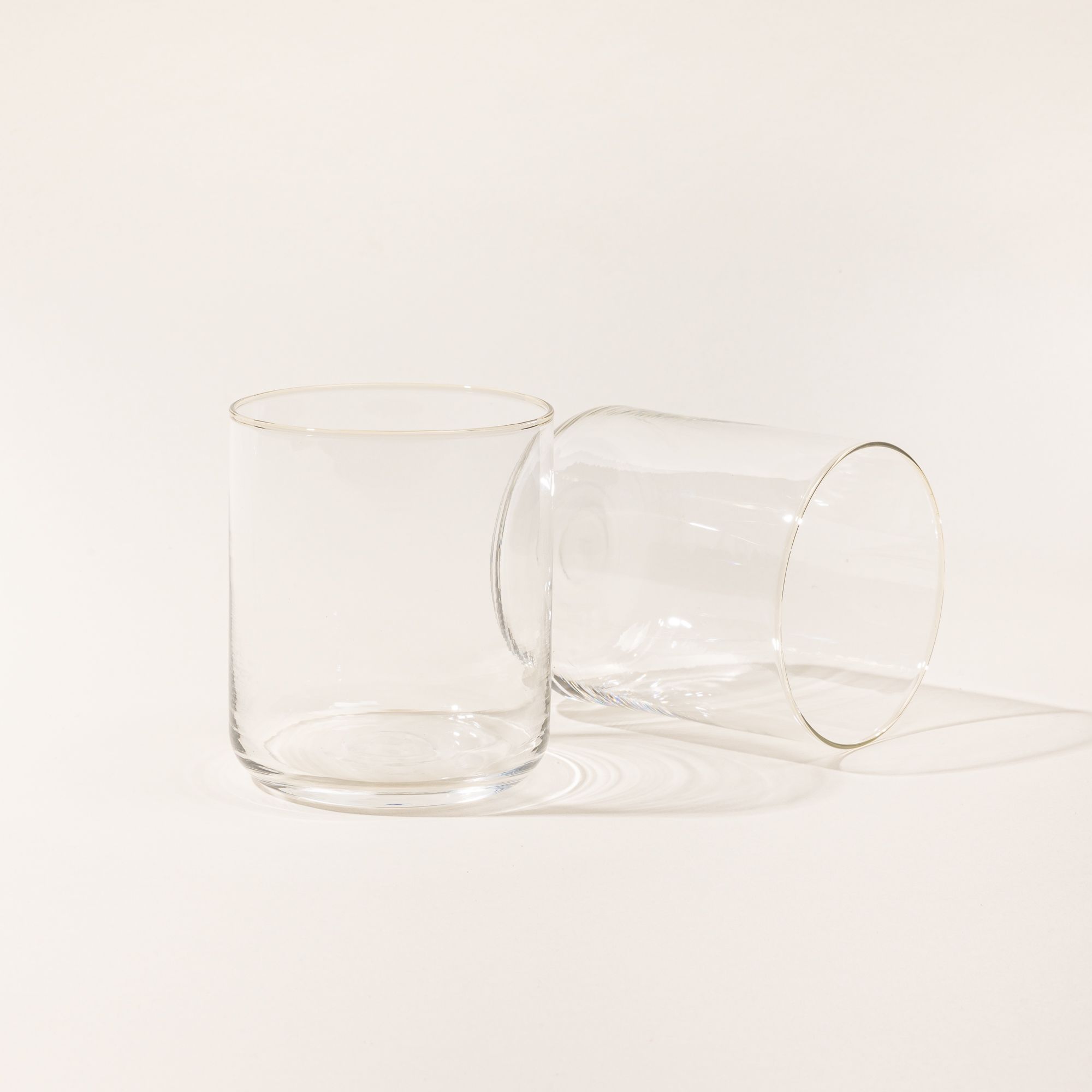 Two straight walled short glass cups