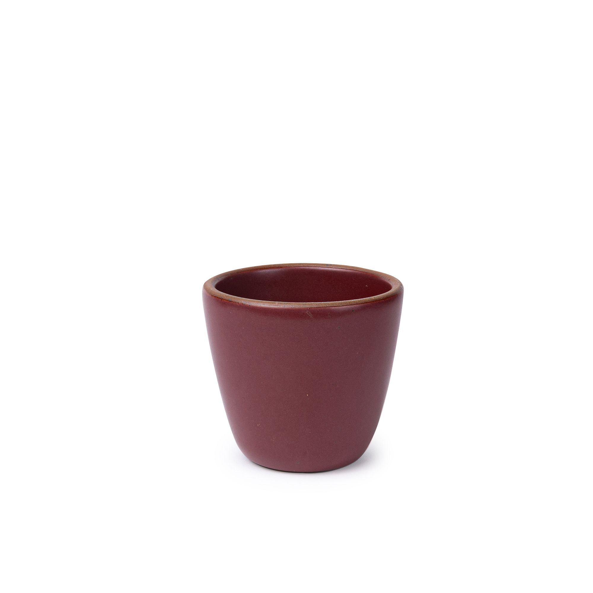 A short cup that tapers out to get wider at the top in a plum color featuring iron speckles