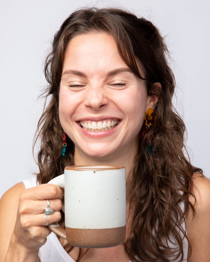 Woman holding mug and smiling