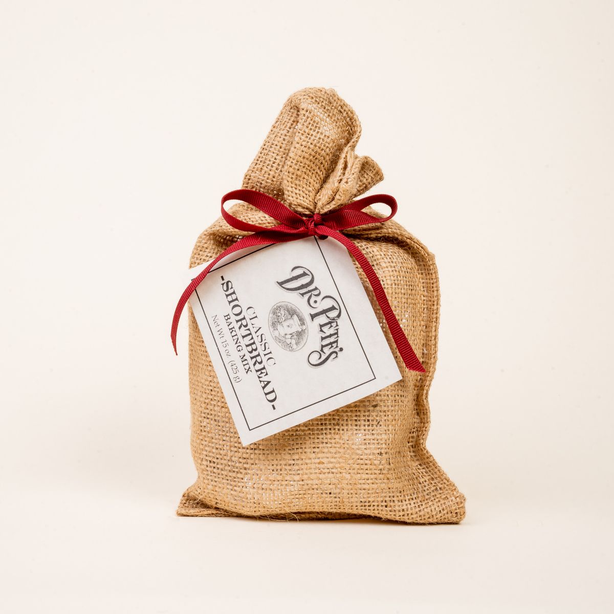 A burlap bag with a red ribbon and a label that reads "Dr. Pete's Shortbread Mix'