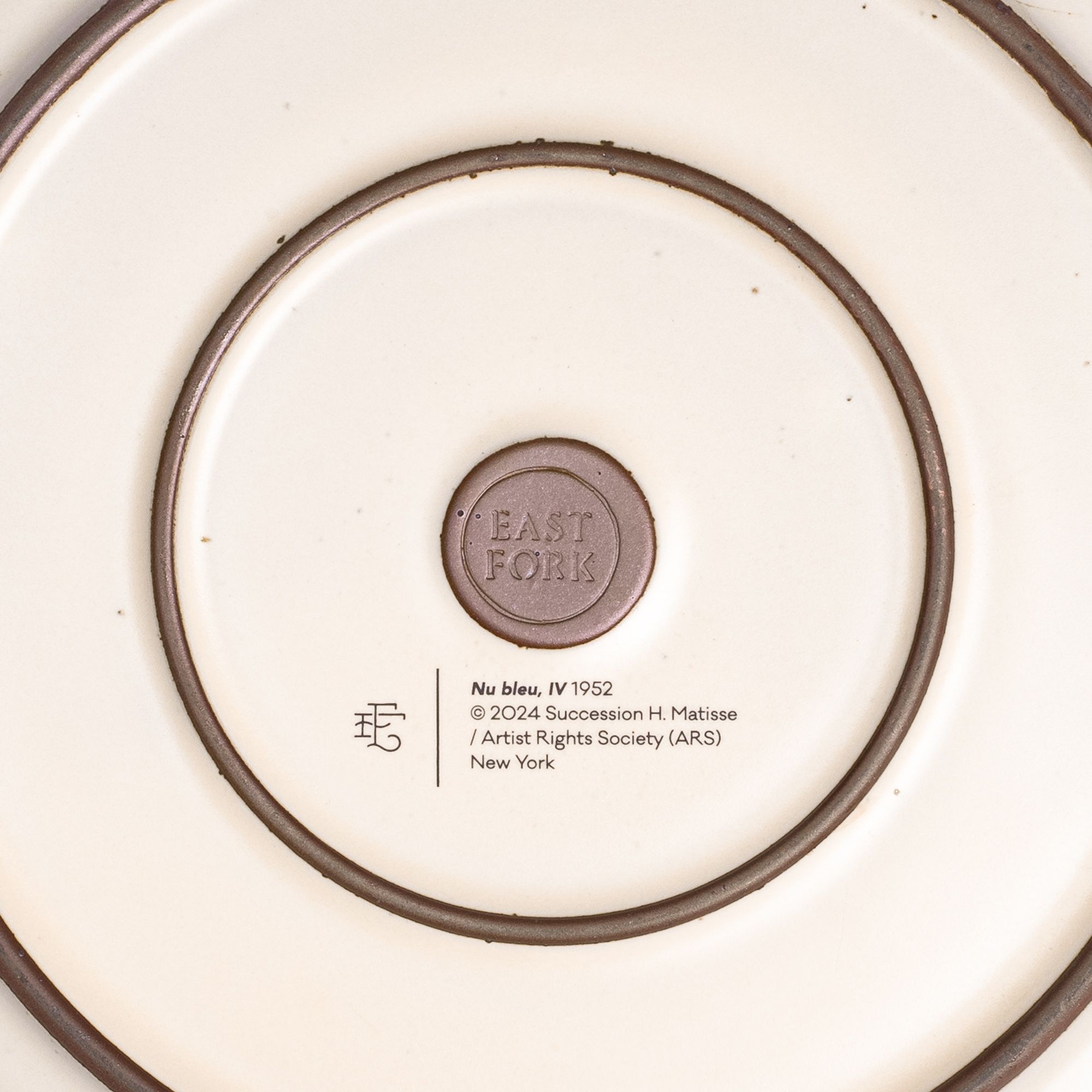 The back of the Dinner Platter with an East Fork stamp with a small decal of information about the artwork.